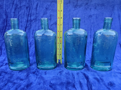 Four (4) matching Dr. Kilmer’s apothecary-style proprietary bottles