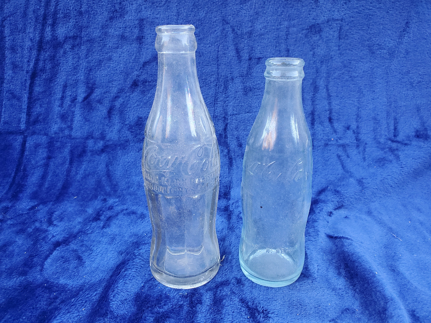 Two Embossed Coca-Cola Bottles 1920–1940