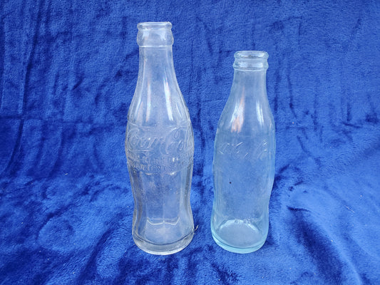 Two Embossed Coca-Cola Bottles 1920–1940