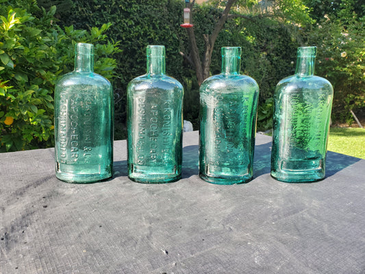 Four (4) matching Dr. Kilmer’s apothecary-style proprietary bottles