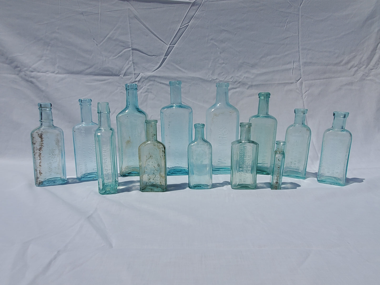 13 Antique Aqua Medicine & Apothecary Bottles – Embossed Glass Collection – 1800s/Early 1900s